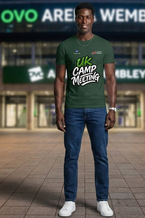 Person wearing a green t-shirt with text standing in front of Wembley Stadium.