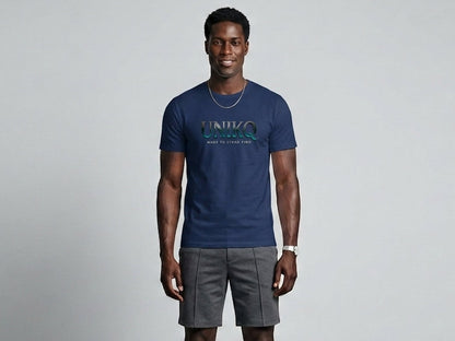Man wearing a blue t-shirt and gray shorts against a plain background